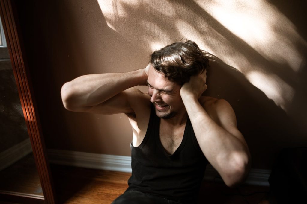 Healing from PTSD and Trauma: A Holistic Approach a man covering his ears