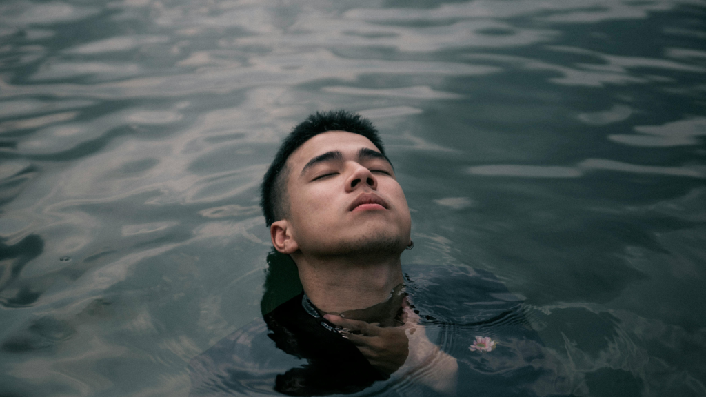 man swimming in a lake