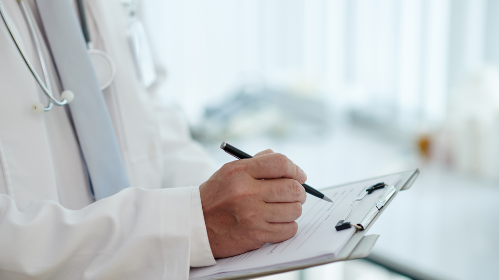 doctor scribbling something on a notepad