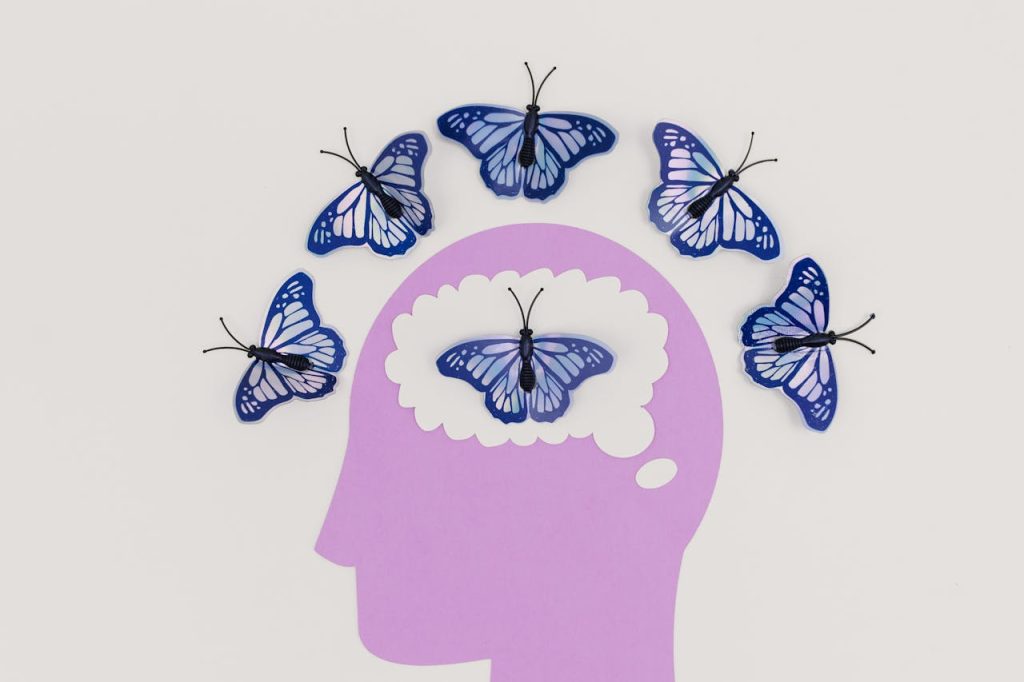 Why Does Psilocybin Work Cover photo with butterflies in a brain