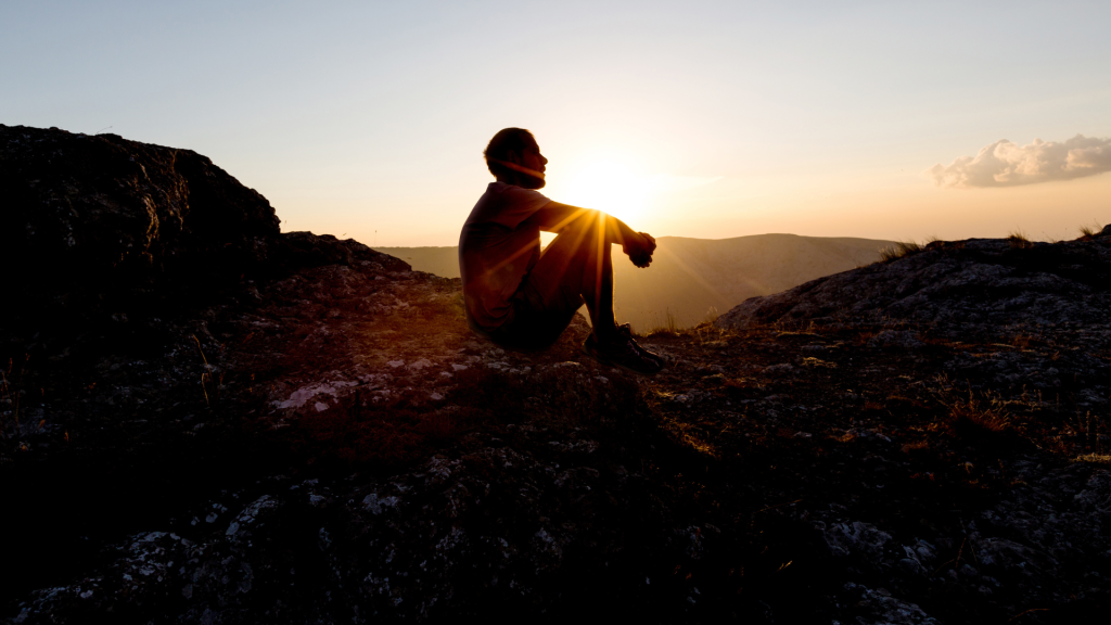 man sitting on some rocks