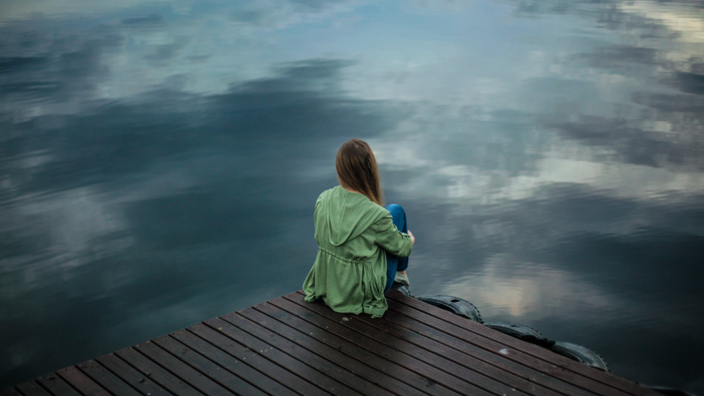 woman sitting on a dock
