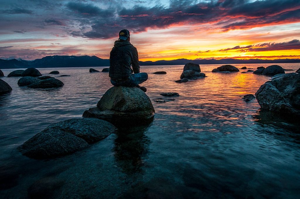 man sitting on rocks after a bad trip from shrooms